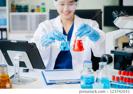female scientist working with micro pipettes analyzing biochemical 123742031