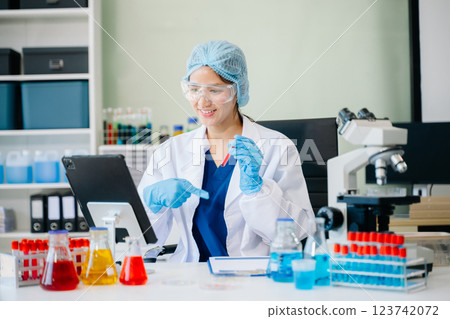 female scientist working with micro pipettes analyzing biochemical 123742072