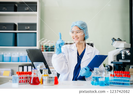 female scientist working with micro pipettes analyzing biochemical female scientist working with micro pipettes analyzing biochemical 123742082