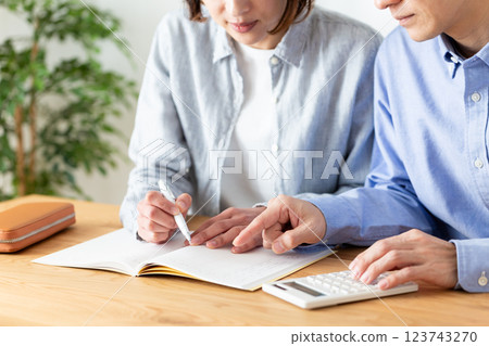 A middle-aged couple keeping a household budget 123743270