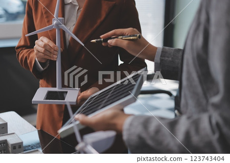 Discussion among businesspeople on the latest developments in solar cell panel technology and Solar Energy Environment city Concept. Discussion among businesspeople on the latest developments in solar cell panel technology and Solar Energy Environment city Concept. 123743404