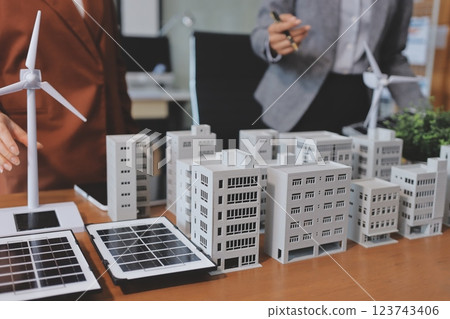 Discussion among businesspeople on the latest developments in solar cell panel technology and Solar Energy Environment city Concept. 123743406