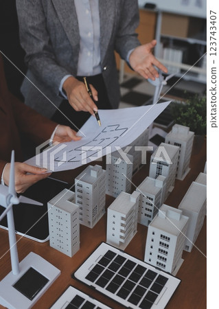 Discussion among businesspeople on the latest developments in solar cell panel technology and Solar Energy Environment city Concept. Discussion among businesspeople on the latest developments in solar cell panel technology and Solar Energy Environment city Concept. 123743407