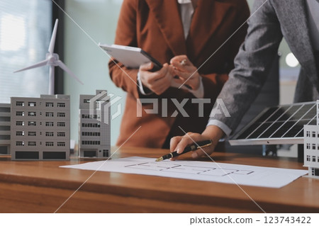 Discussion among businesspeople on the latest developments in solar cell panel technology and Solar Energy Environment city Concept. 123743422