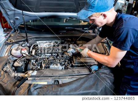 Car mechanic repair engine at service station. Car repair 123744803