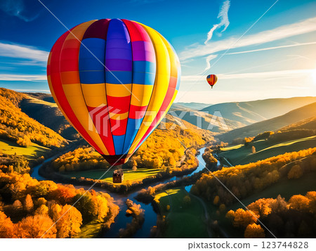 Beautiful hot air balloon flying over the valley with blue river and colorful forest in  autumn season. 123744828