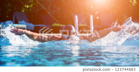 Young athletic man swimming in the swimming pool 123744865
