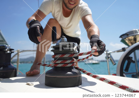 A man in a white hat is working on a voyage boat A man in a white hat is working on a voyage boat 123744867