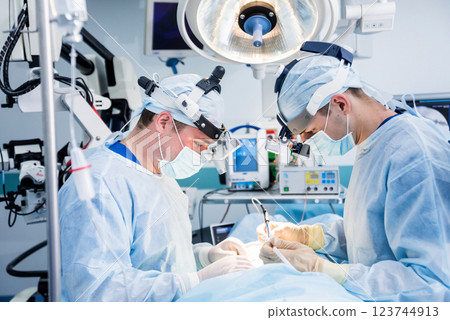 Spinal surgery. Group of surgeons in operating room with surgery equipment. Spinal surgery. Group of surgeons in operating room with surgery equipment. 123744913