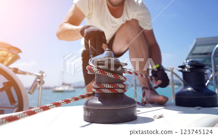 A man in a white hat is working on a voyage boat 123745124