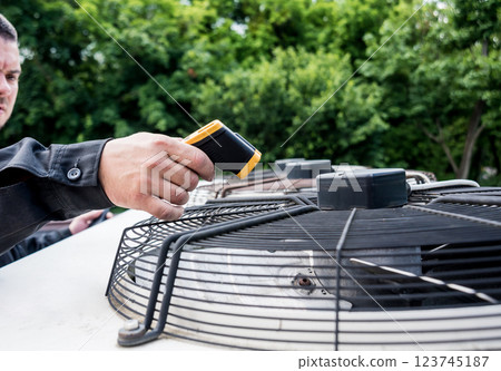 Technician use infrared thermal imaging camera to check temperature at fuse-box 123745187