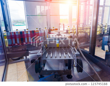 Automatic labeling machine during operation. Factory for the production Automatic labeling machine during operation. Factory for the production 123745188