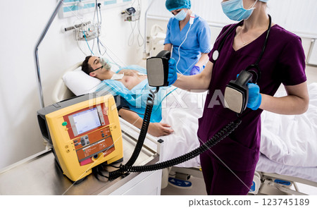 Doctors give resuscitation to a male patient in the emergency room. Doctors give resuscitation to a male patient in the emergency room. 123745189
