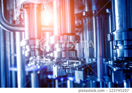 Automatic filling machine pours water into plastic PET bottles. Automatic filling machine pours water into plastic PET bottles. 123745207