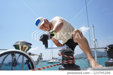 A man in a white hat is working on a voyage boat A man in a white hat is working on a voyage boat 123745208