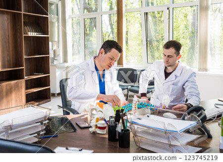 Doctor show polyaxial screw on the spine model. Spine fixation systems 123745219