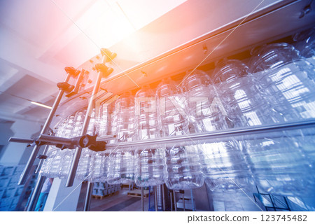 Bottling line of sunflower oil in bottles. Vegetable oil production plant.  123745482