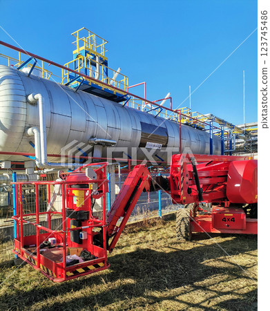 Steel structure is under construction on the construction site against a blue sky backdrop Steel structure is under construction on the construction site against a blue sky backdrop 123745486