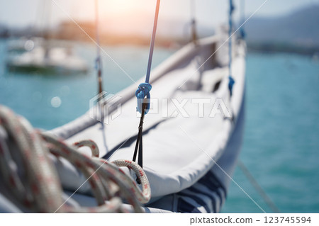 A white voyage boat featuring a steering wheel floating in the water A white voyage boat featuring a steering wheel floating in the water 123745594