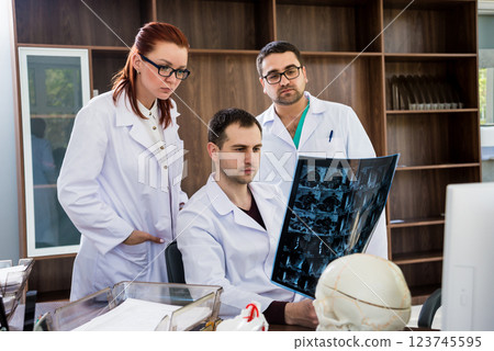 Doctors team having medical council in hospital. Discussing medical issues. Doctors team having medical council in hospital. Discussing medical issues. 123745595