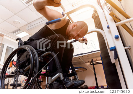 Disabled man training in the gym. Rehabilitation center Disabled man training in the gym. Rehabilitation center 123745620
