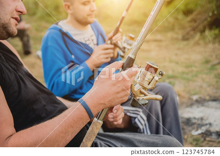 Handicapped men fishing at a lake. Wheelchair. Camping. 123745784