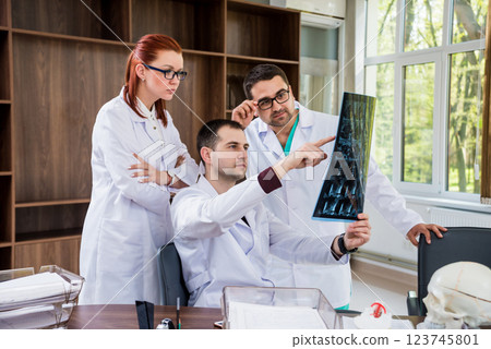 Doctors team having medical council in hospital. Discussing medical issues. Doctors team having medical council in hospital. Discussing medical issues. 123745801