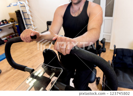 Disabled man training in the gym. Rehabilitation center Disabled man training in the gym. Rehabilitation center 123745802