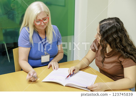 Girl studying with teacher Girl studying with teacher 123745839
