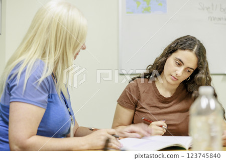 Girl studying with teacher 123745840