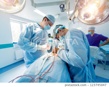 Spinal surgery. Group of surgeons in operating room with surgery equipment. Spinal surgery. Group of surgeons in operating room with surgery equipment. 123745847