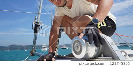 A man in a white hat is working on a voyage boat A man in a white hat is working on a voyage boat 123745895