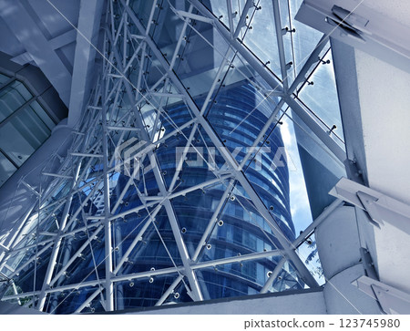 A modern tall building that features a significant amount of glass A modern tall building that features a significant amount of glass 123745980