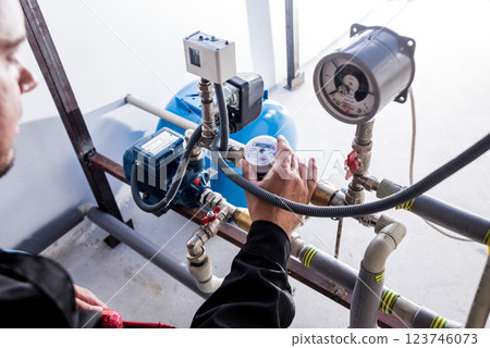 Technician checking water system nodes.Modern Industrial background 123746073