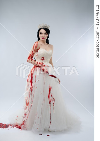 Bridal beauty covered in blood with a knife in hand symbolizing a dark fantasy 123746112