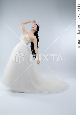 Bridal beauty showcasing elegance and charm in a stunning white gown Bridal beauty showcasing elegance and charm in a stunning white gown 123746114