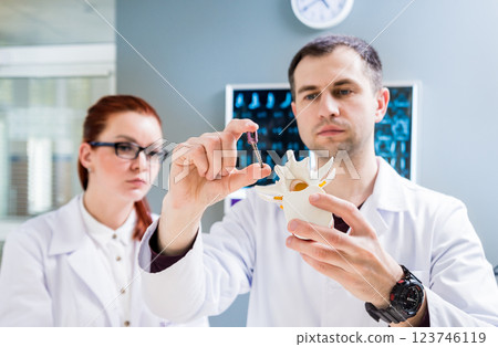 Doctors team having medical council in hospital. Spine fixation systems 123746119