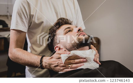 Young man with trendy haircut at barber shop.  123746143