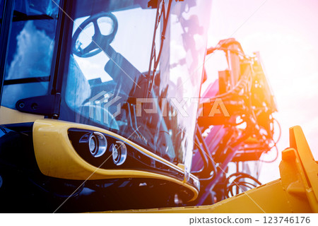 Modern agricultural machinery and equipment. Yellow agricultural harvester. 123746176