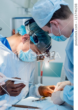 Spinal surgery. Group of surgeons in operating room with surgery equipment. Spinal surgery. Group of surgeons in operating room with surgery equipment. 123746208