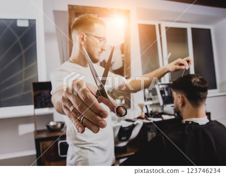 Young man with trendy haircut at barber shop.  123746234