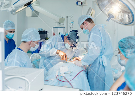 Spinal surgery. Group of surgeons in operating room with surgery equipment. Spinal surgery. Group of surgeons in operating room with surgery equipment. 123746270