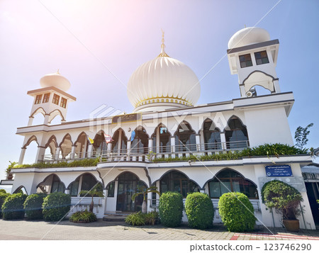 The mosque with the minaret is designed in the Islamic architectural tradition. The mosque with the minaret is designed in the Islamic architectural tradition. 123746290