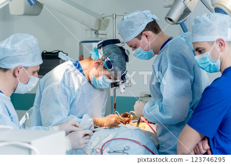 Spinal surgery. Group of surgeons in operating room with surgery equipment. Spinal surgery. Group of surgeons in operating room with surgery equipment. 123746295