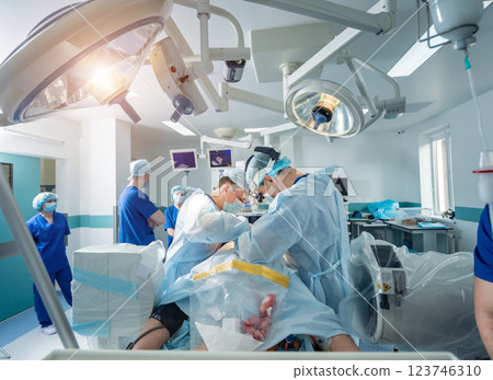 Spinal surgery. Group of surgeons in operating room with surgery equipment. Spinal surgery. Group of surgeons in operating room with surgery equipment. 123746310