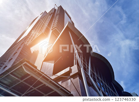 A modern tall building that features a significant amount of glass 123746330
