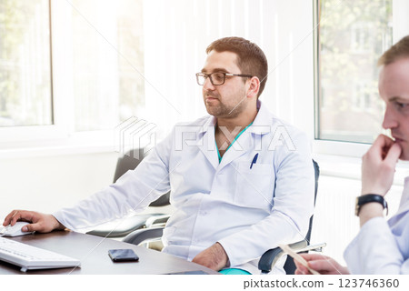 Two doctors having medical council in hospital. Discussing medical issues. Two doctors having medical council in hospital. Discussing medical issues. 123746360
