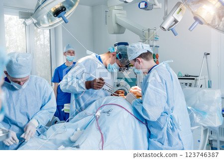 Spinal surgery. Group of surgeons in operating room with surgery equipment. Spinal surgery. Group of surgeons in operating room with surgery equipment. 123746387