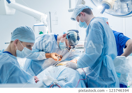 Spinal surgery. Group of surgeons in operating room with surgery equipment. Spinal surgery. Group of surgeons in operating room with surgery equipment. 123746394