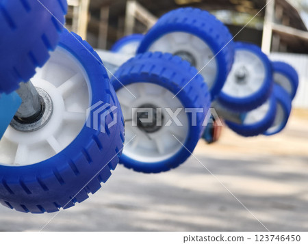 Detailed closeup of a boat trailer that features striking blue wheels 123746450